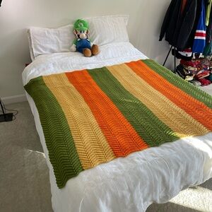Striped Green, Orange, and Tan Knit Blanket